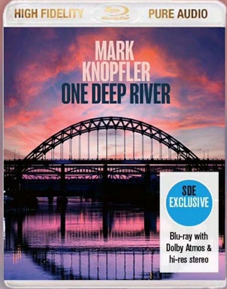 May include: Blu-ray disc for Mark Knopfler's album "One Deep River." The cover features a bridge silhouette over a river at sunset, with text reading "HIGH FIDELITY" and "PURE AUDIO." Includes "SDE EXCLUSIVE" and "Blu-ray with Dolby Atmos & hi-res stereo."