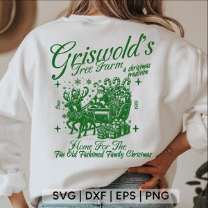 May include: White sweatshirt with a green design that says "Griswold's Tree Farm, a Christmas tradition since 1989." The design also includes a Santa Claus in a sleigh pulled by reindeer.