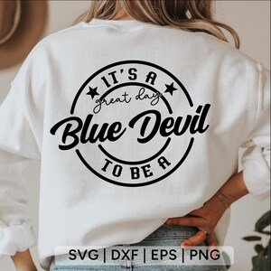 May include: White sweatshirt with the text "IT'S A great day Blue Devil TO BE A" in black script and a circular design. The bottom of the image shows the text "SVG | DXF | EPS | PNG".