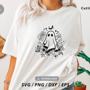 May include: A white t-shirt with a black and white design of a ghost with flowers and a bat. The text "Cutting" is in the top right corner of the image. The text "SVG/PNG/DXF/EPS" is in the bottom center of the image.