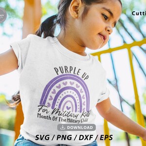 May include: A white t-shirt with a purple rainbow design and the text "Purple Up For Military Kids Month Of The Military Child".