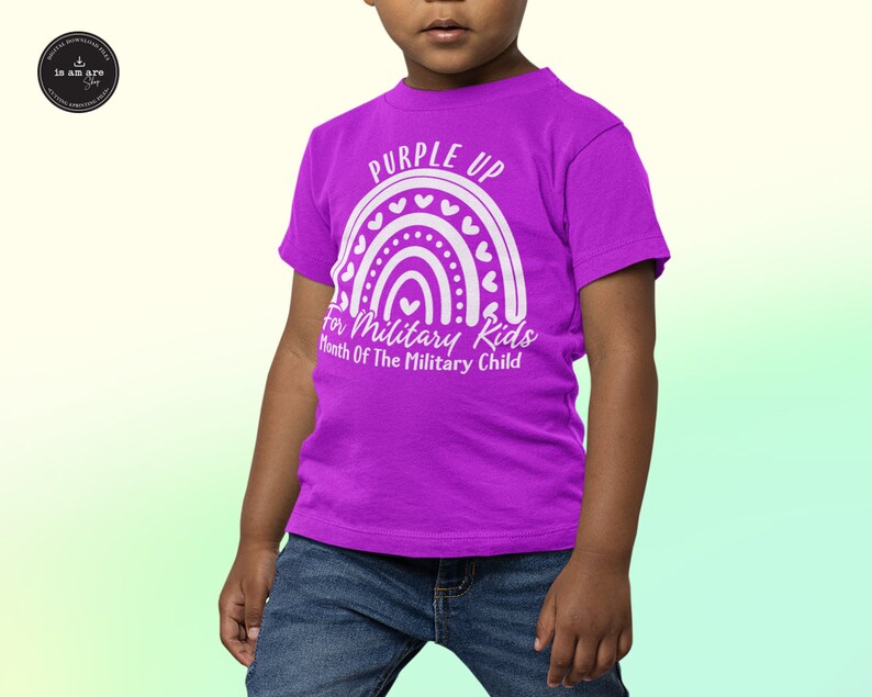May include: A purple t-shirt with a white rainbow design and the text "Purple Up for Military Kids Month of the Military Child".