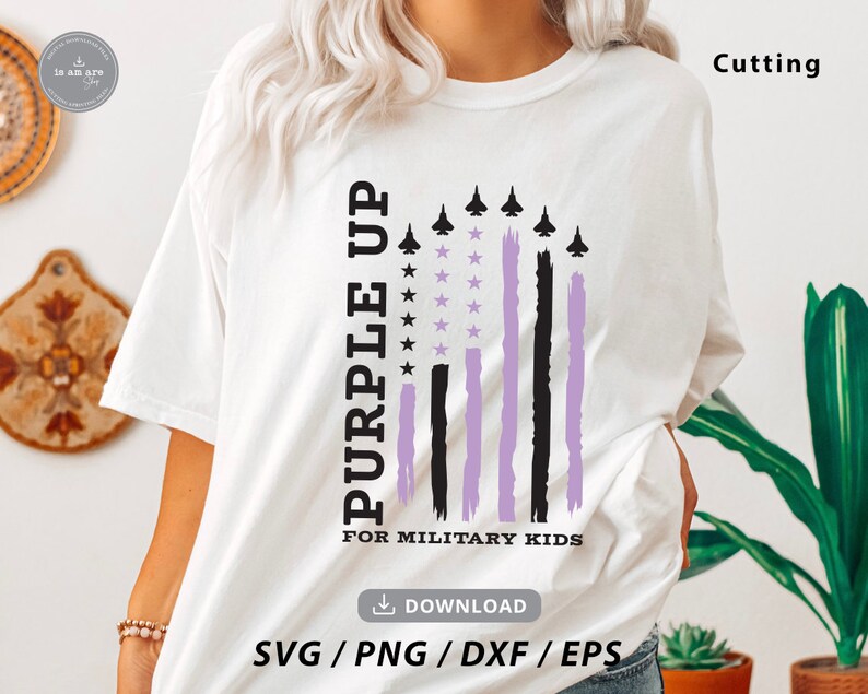 May include: White t-shirt with a purple up for military kids design. The design features a purple and black American flag with stars and aeroplanes.
