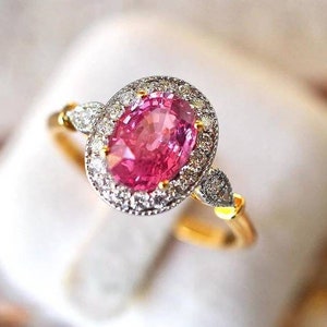 Edwardian Pink Sapphire Engagement Ring in Halo and Pavè Setting. Oval cut Pink Sapphire set in a Halo Ring. Art Deco