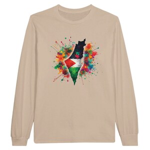 May include: A long-sleeve shirt in a neutral beige color. The shirt features a watercolor design of the Palestinian flag within the shape of the country, surrounded by colorful paint splatters. The design is centered on the front.