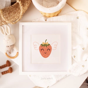 May include: A white framed print with a cute cartoon strawberry with wings and a bow. The strawberry is red with a green stem and yellow seeds. The background is white with a light pink border.