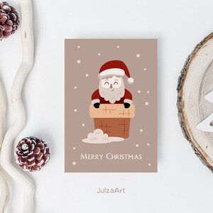 Puede incluir: Una tarjeta de Navidad con una ilustraci&oacute;n de dibujos animados de Pap&aacute; Noel en una chimenea. La tarjeta es marr&oacute;n con copos de nieve blancos y el texto "Feliz Navidad".