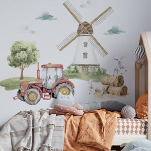 May include: A red tractor, a white windmill, and two brown hay bales are part of a farm-themed wall decal set. The decals are on a white wall in a child's bedroom.