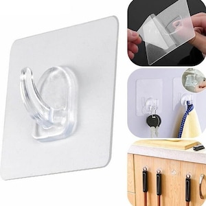 May include: A set of four clear plastic adhesive hooks. The hooks are mounted on a white square base. The hooks are designed to be used on smooth surfaces such as walls, tiles, and cabinets. The hooks are shown in various applications, including hanging keys, towels, and utensils.