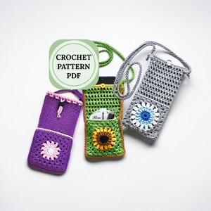 May include: Three handmade crochet phone cases in purple, green, and gray. The purple case has a flower design and a drawstring closure. The green case features a sunflower and a pocket. The gray case has a blue and white flower design. The image includes the text "CROCHET PATTERN PDF".