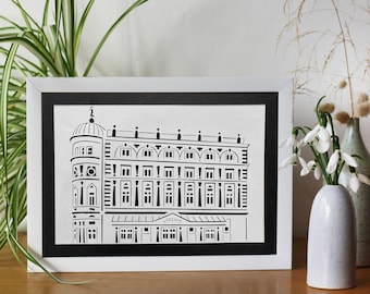 May include: A black and white paper cut-out illustration of a building with a dome, framed in a white frame. The building has a sign that reads "LYCEUM".