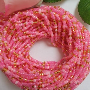 Pretty pink and gold waist beads, hand strung on white cotton thread.