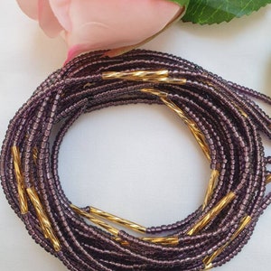 Purple/mauve waist beads with gold bars