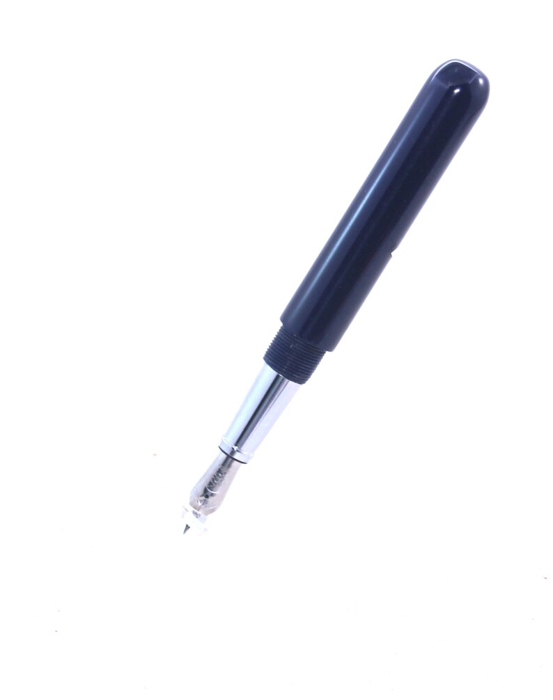 May include: A black fountain pen with a silver nib and a black cap.