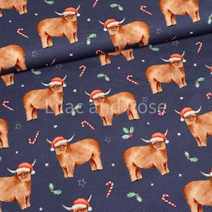 May include: A navy blue fabric with a repeating pattern of brown Highland cows wearing Santa hats. The cows are surrounded by red candy canes and green holly sprigs.
