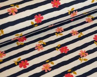 May include: White fabric with navy blue stripes and a pink floral pattern. The fabric has a soft, textured feel.