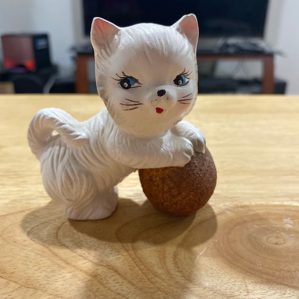 Ceramic cat playing with ball