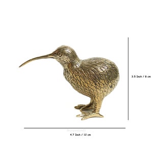 May include: A gold-colored brass sculpture of a kiwi bird. The sculpture is 4.7 inches tall and 3.5 inches wide.