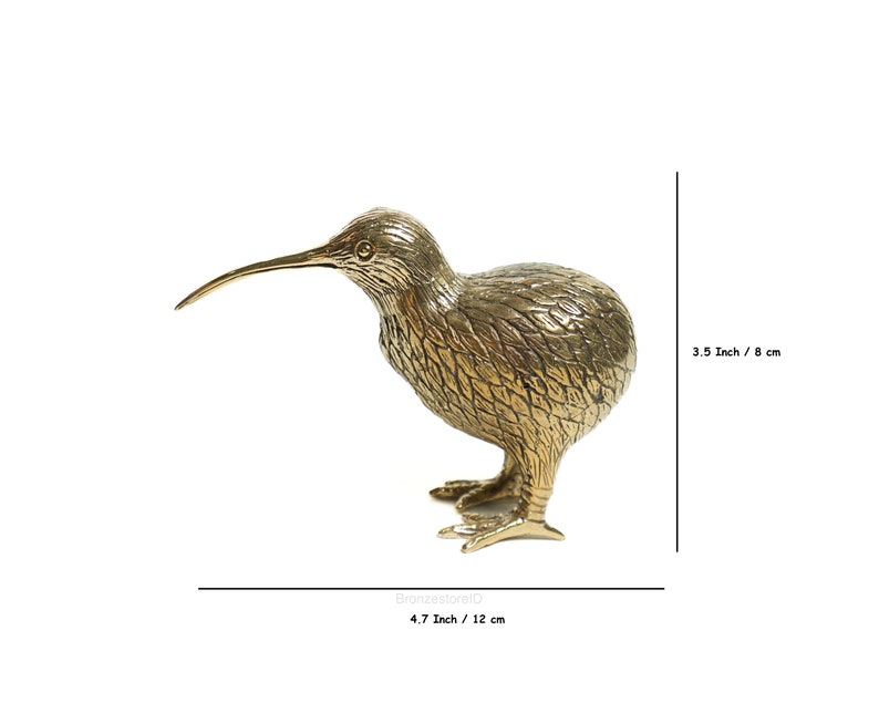 May include: A gold-colored brass sculpture of a kiwi bird. The sculpture is 4.7 inches tall and 3.5 inches wide.