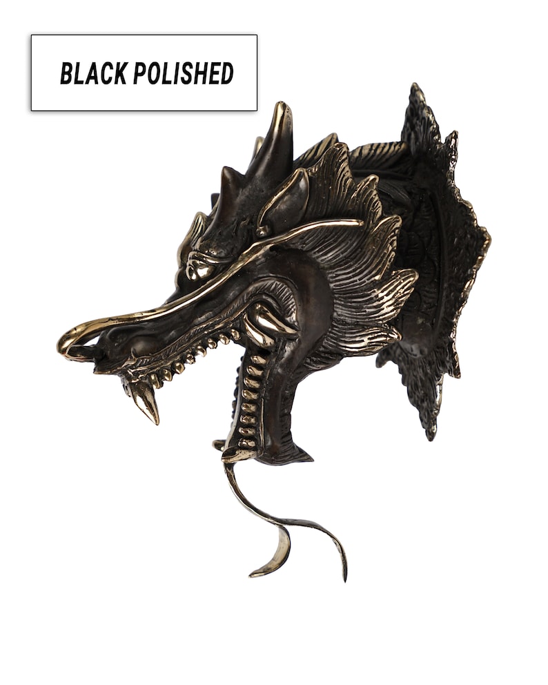 May include: Black polished dragon head wall mount sculpture with gold accents. The dragon has a fierce expression with sharp teeth and claws.