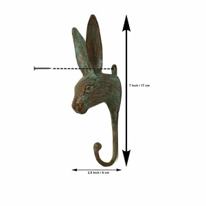 May include: A green metal rabbit head hook with a 7 inch / 17 cm height and a 2.5 inch / 6 cm width.