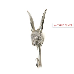 May include: Antique silver rabbit head wall hook. The hook is shaped like a rabbit's head with long ears and a detailed face.