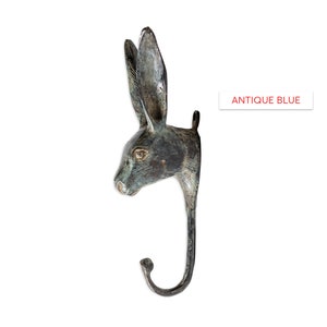 May include: Antique blue rabbit head wall hook. The hook is made of metal and has a realistic rabbit head design. The hook is perfect for hanging coats, hats, or other items.