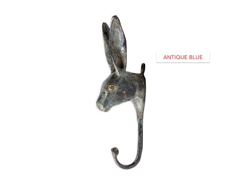 May include: Antique blue rabbit head wall hook. The hook is made of metal and has a realistic rabbit head design. The hook is perfect for hanging coats, hats, or other items.