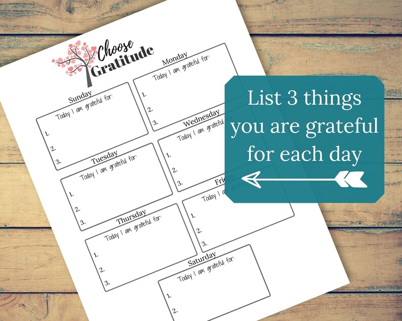 May include: A printable gratitude journal with a black and white design. The journal is divided into seven sections, one for each day of the week. Each section has a space for listing three things you are grateful for. The text "Choose Gratitude" is at the top of the page. The text "List 3 things you are grateful for each day" is in a teal box with a white arrow pointing to the left.
