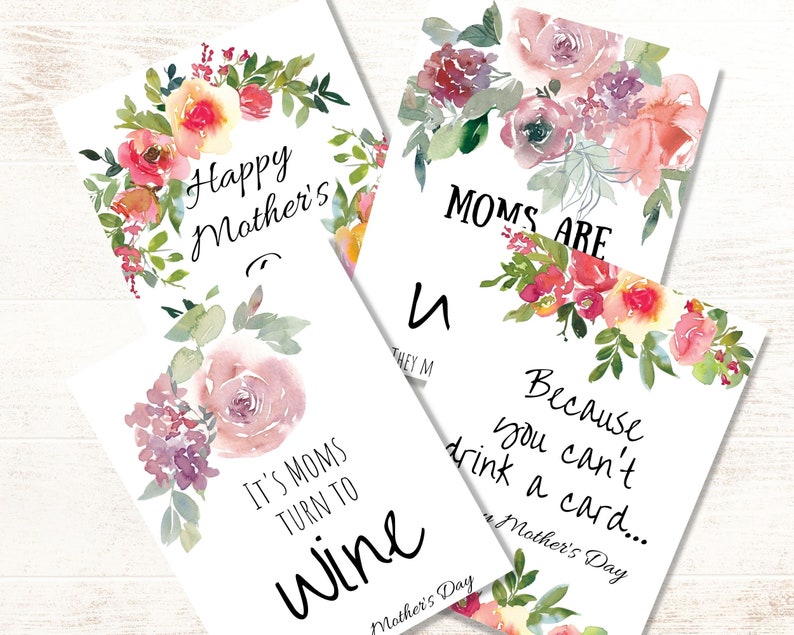 May include: Four printable Mother's Day cards with watercolor floral designs. The cards feature the text "Happy Mother's", "Moms Are", "It's Moms Turn To Wine", and "Because You Can't Drink A Card..."