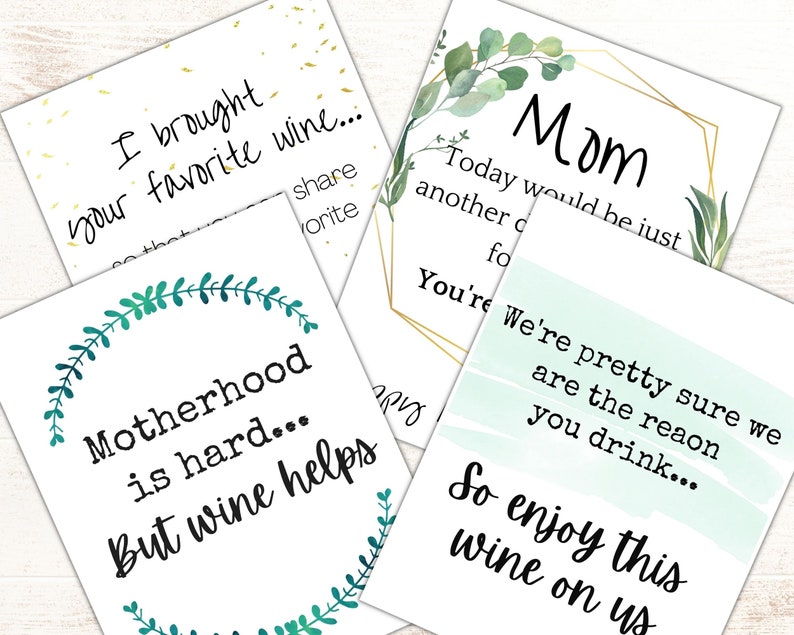 May include: Four printable cards with green foliage and gold accents. The cards feature humorous sayings about wine and motherhood. The text on the cards reads: "I brought your favorite wine...", "Mom Today would be just another day for... You're pretty sure we are the reason you drink... So enjoy this wine on us", "Motherhood is hard... But wine helps", and "Today would be just another day for... You're pretty sure we are the reason you drink... So enjoy this wine on us".