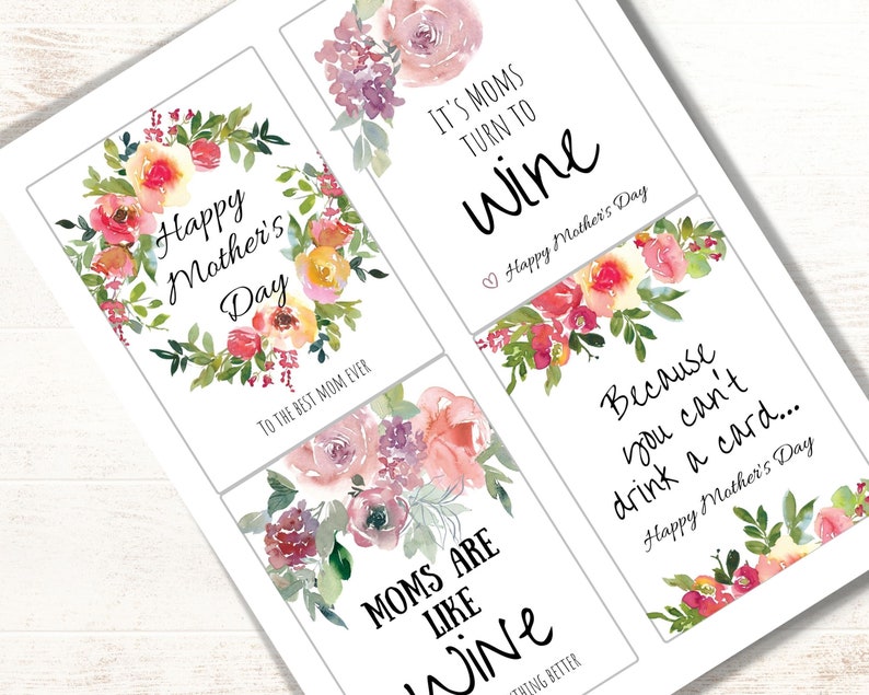 May include: Four printable Mother's Day gift tags with watercolor floral designs. The tags feature the text "Happy Mother's Day", "It's Moms Turn To Wine", "Moms Are Like Wine", and "Because You Can't Drink A Card..."