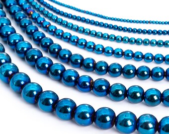May include: Multiple strands of shiny, dark blue beads, each strand with a different size bead. The beads are round and have a metallic finish.