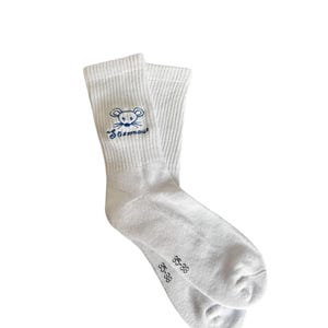 May include: A pair of white socks with a blue embroidered mouse design and the word "Sossmou" above the mouse. The socks have a ribbed texture and the size "35-38" is printed on the foot.