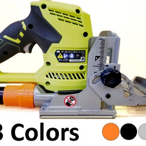 May include: A green and black power tool with a gray base and a black knob. The tool has a depth gauge and a dust collection port. The tool is on a wooden surface. 3 Colors: Orange, Black, Gray.