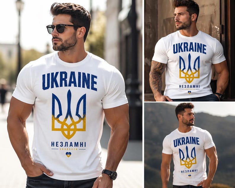 Op de afbeelding: Wit T-shirt met het woord "UKRAINE" in blauw, boven een blauw en geel embleem. De tekst "НЕЗЛАМНІ" staat eronder. Het T-shirt wordt door een persoon gedragen.