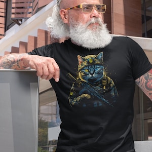 以下が含まれることがあります： 黒いTシャツ。軍服を着てライフルを持っている猫の詳細なイラスト。猫は黄色と青の目を持ち、紋章が付いた軍用帽子をかぶっています。デザインは黒い背景にあります。