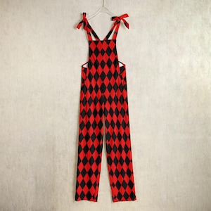 May include: Red and black diamond patterned overalls with adjustable straps.