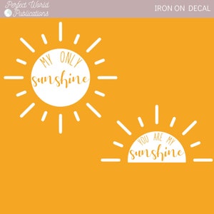 May include: Two white iron-on decals featuring sun designs with the text "My Only Sunshine" and "You Are My Sunshine".