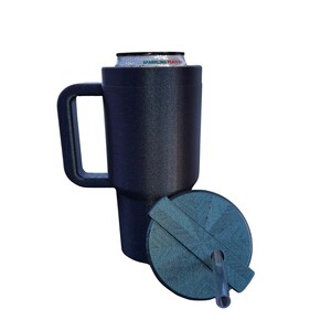 May include: A dark navy blue textured can cooler with a handle, holding a Sparkling Peach beverage can. A matching circular lid with a geometric pattern and a clear plastic straw is positioned in front of the cooler on a white background.
