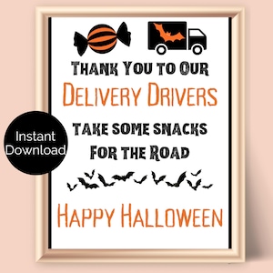 May include: A framed sign with a Halloween theme, featuring black and orange graphics and text. The sign says "Thank You to Our Delivery Drivers" and "Take Some Snacks For The Road." Includes a candy graphic and bat silhouettes.