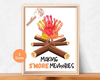 May include: Framed print featuring a campfire design made with handprints in red, yellow, and orange. A marshmallow on a stick is above the fire. The text "MAKING S'MORE MEMORIES" is below the campfire. A small orange circle indicates "3 Sizes".