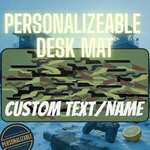 May include: A rectangular desk mat with a camouflage pattern in shades of green, brown, and black. The words "PERSONALIZABLE DESK MAT" and "CUSTOM TEXT/NAME" are displayed in white. A circular "PERSONALIZABLE" logo is in the lower left.