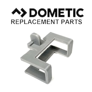 May include: A gray plastic replacement part for a Dometic refrigerator. The part is shaped like a U with a small tab on one side.