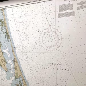 May include: A nautical chart of the North Atlantic Ocean, featuring detailed coastlines, depth soundings, and navigational aids. The map includes a compass rose and the text "NORTH ATLANTIC OCEAN". The chart is printed on a large sheet of paper.