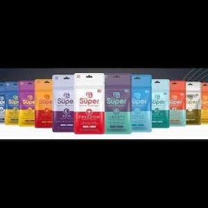 May include: A collection of colorful supplement packets, each with a white top and a clear window. The packets are labeled with the word "Super" and various product names like "Freedom" and "Liberty". The background is black.