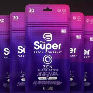 May include: A display of multiple purple and blue pouches from "The Super Patch Company." Each pouch is labeled "ZEN SUPER PATCH" and contains 30 patches. The packaging includes the text "GET IN THE ZONE LIKE NEVER BEFORE."