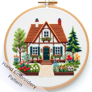 May include: A hand-stitched embroidery pattern of a charming cottage with a brown roof, white walls, and green shutters. The cottage is surrounded by a lush garden with colorful flowers and trees. The pattern is framed in a wooden hoop.
