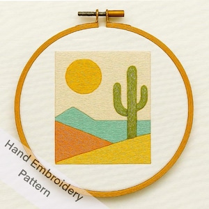 May include: Hand embroidery pattern featuring a desert landscape with a yellow sun, green cactus, and colorful terrain. The design is framed in a wooden embroidery hoop. The text "Hand Embroidery Pattern" is visible.