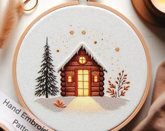 Peut inclure: Broderie représentant un chalet douillet dans la neige avec une fenêtre qui brille. Le chalet est en rondins de bois et a un toit enneigé. Il y a un pin à gauche du chalet et un petit buisson à droite. Le motif est entouré d'un fond blanc avec quelques flocons de neige éparpillés.